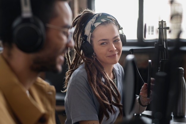 Student practicing vocal exercises with guidance from experienced singing coach