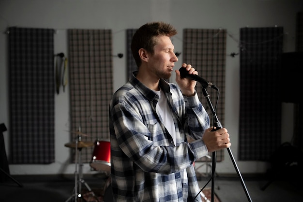 Modern music studio setup featuring microphone and equipment for voice training sessions